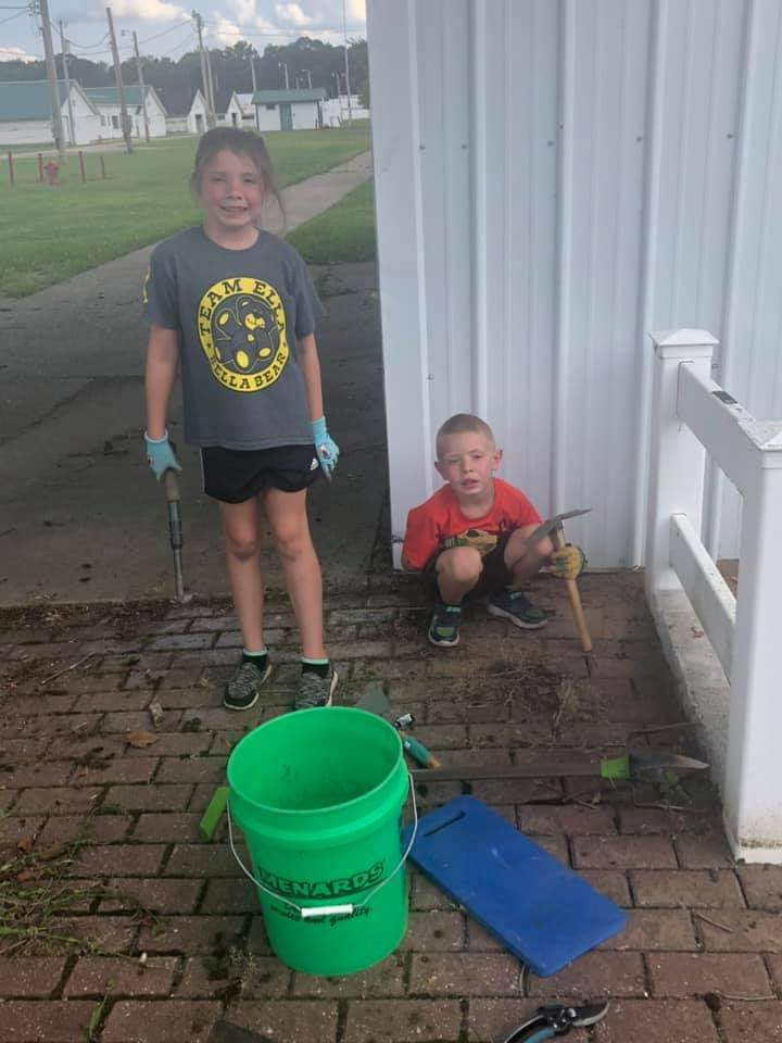 Youth cleaning up the fairgrounds.